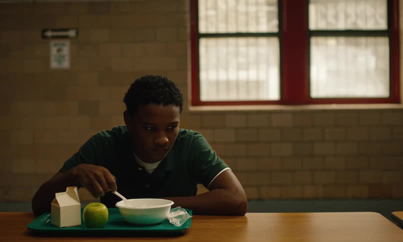 A prisoner eats at a table alone