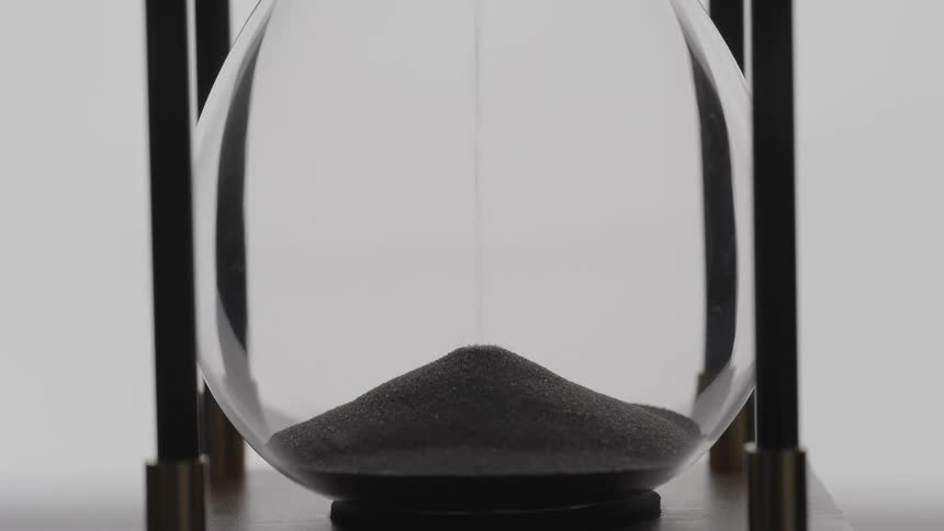 Sand falling inside of an hourglass
