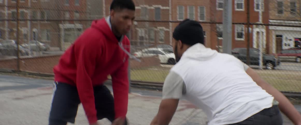 Two people are playing basketball together