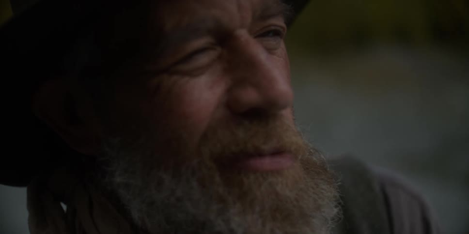 Portrait of a man smiling and wearing a hat outdoors