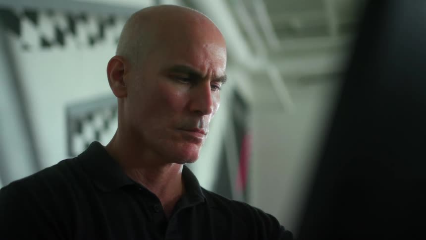 Man staring back and forth at a board in front of him