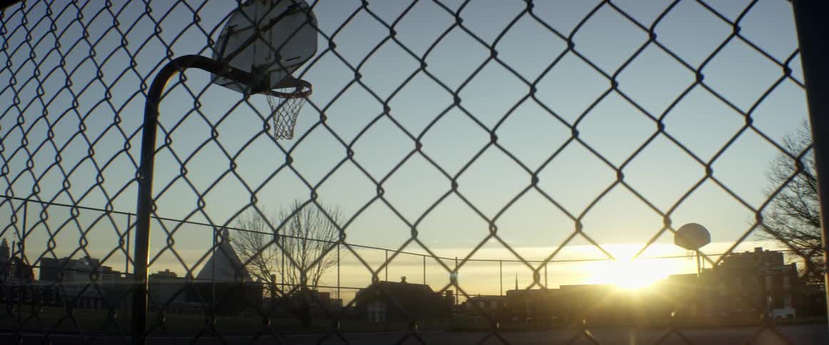 A basketball court is empty at dawn