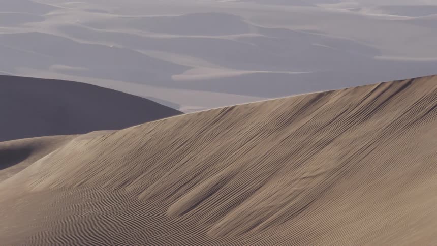 Sand dunes stretch out toward the horizon