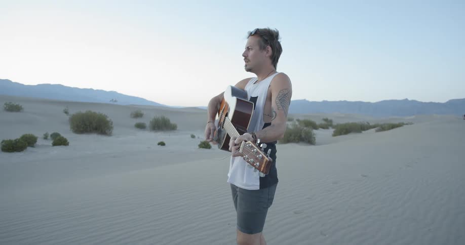 A man is playing his guitar