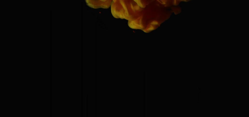 Orange smoke moves down in the dark