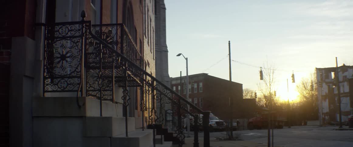 The sun is setting behind these buildings