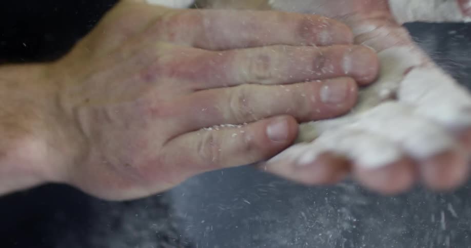 A man rubs chalk in his hands