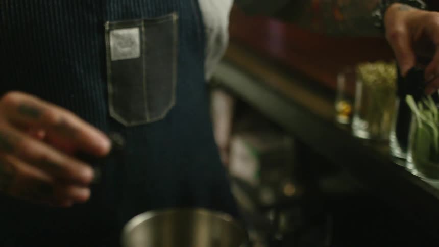 A bartender is preparing drinks
