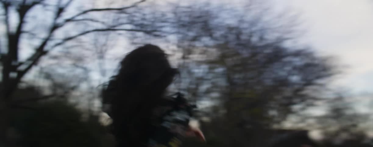 Smiling woman runs through a park