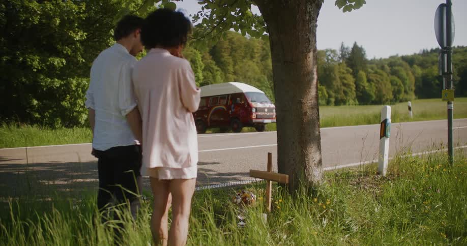 Couple standing on a road with forest landscape