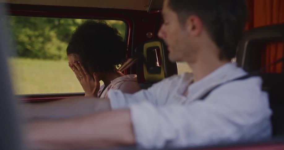 Couple inside a vehicle looking sad