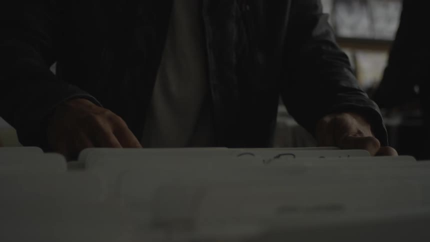 A person is shopping for records