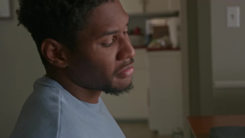 A man is angry and sitting by his computer
