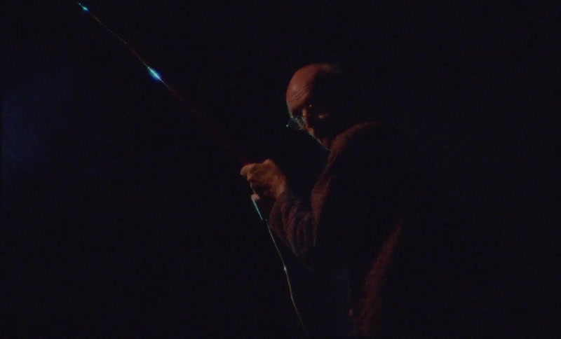 A man is holding a long object outside