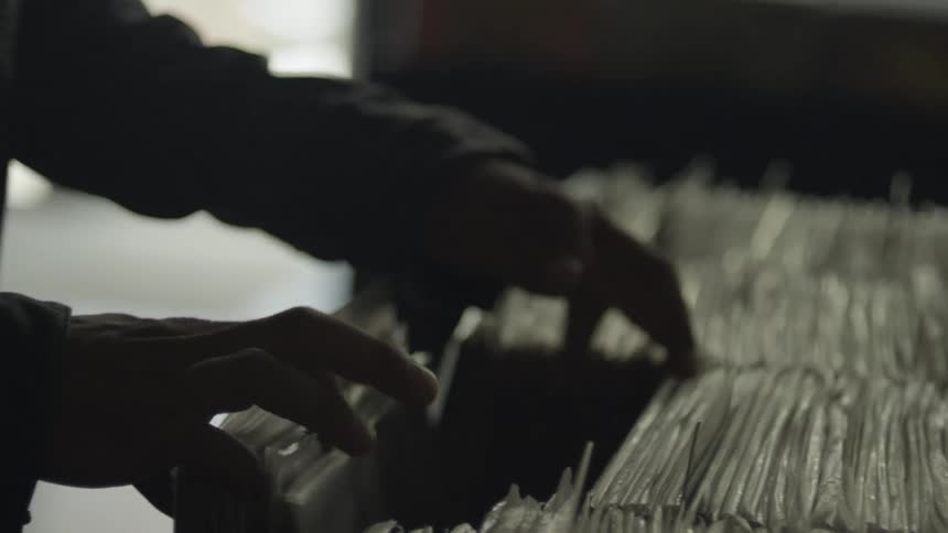 Person looking for documents wrapped in plastic