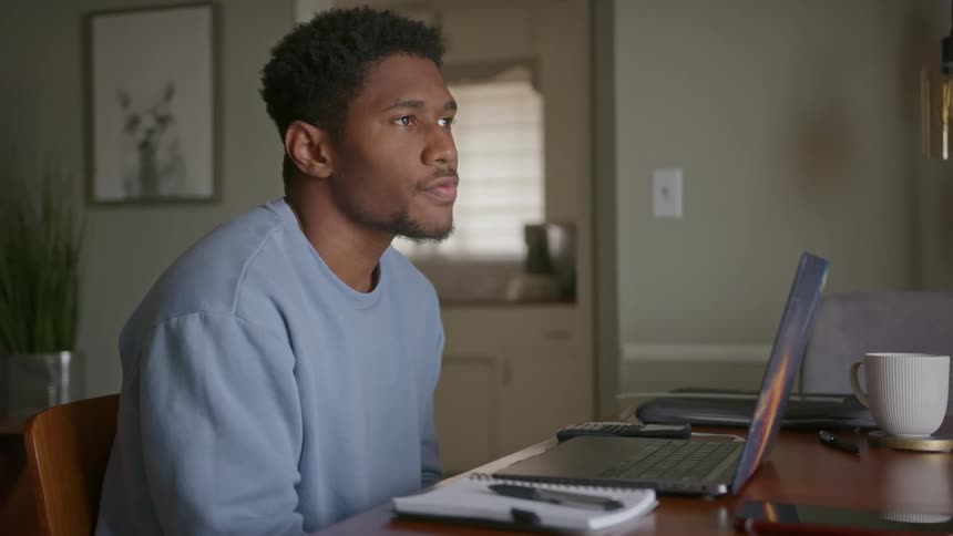 Man with laptop computer working in a home office