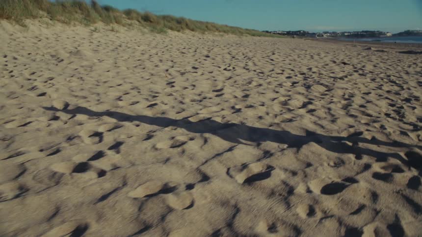 A child is walking on the beach