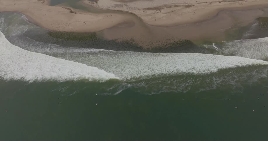 Waves wrap around the shore at a pointbreak in Malibu
