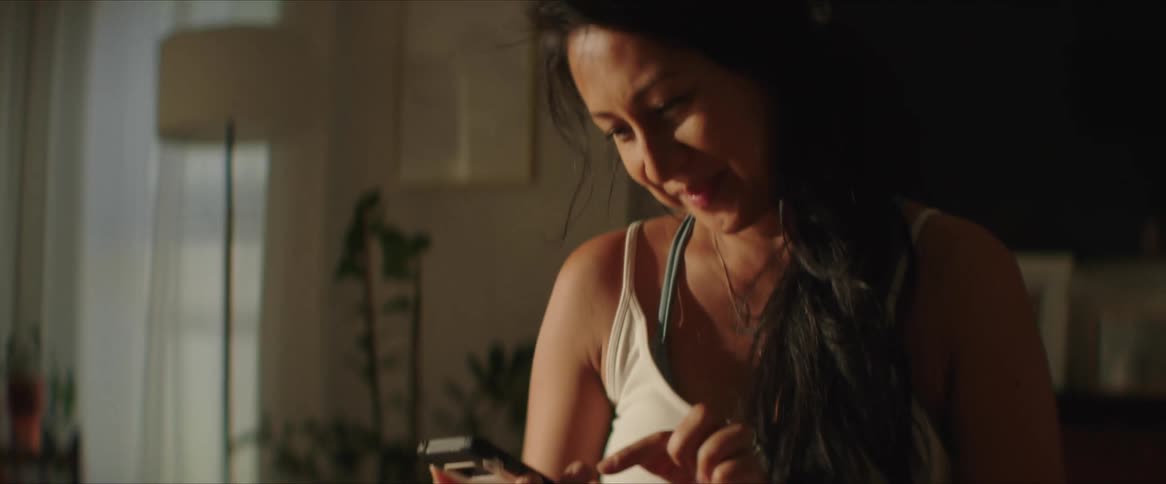 Smiling pregnant woman using her smartphone