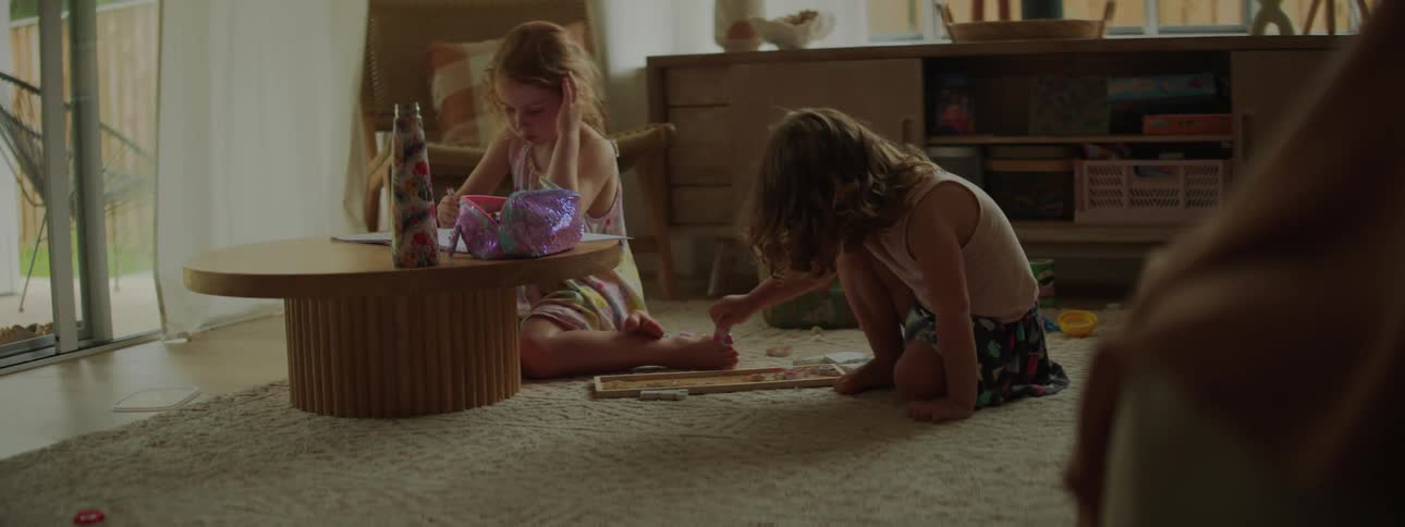 Two children are playing in the living room