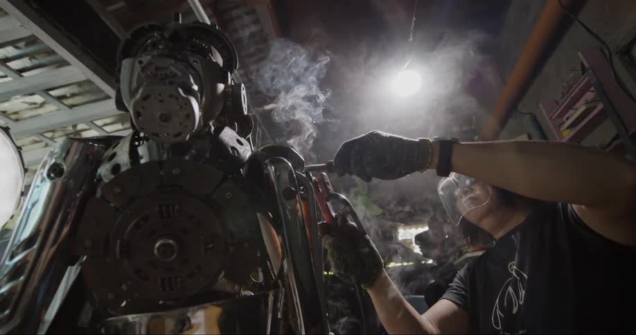 A man is welding a robot