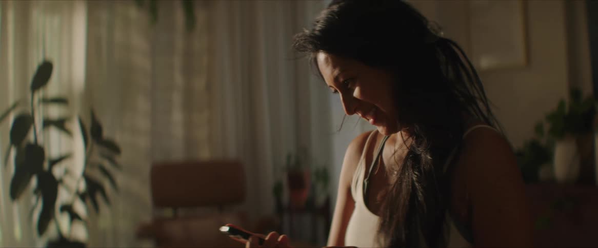 A woman takes a selfie at home