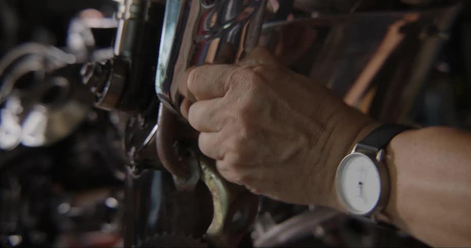 A man is tightening a bolt
