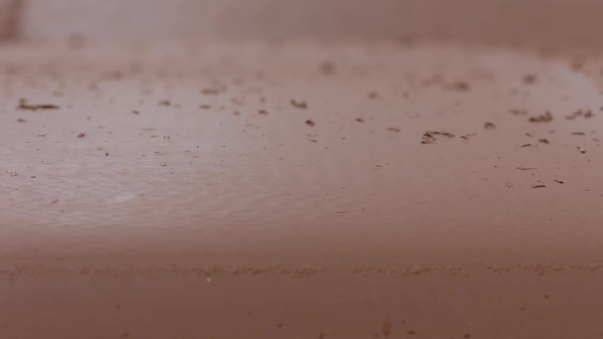 Pan over clay surface with debris