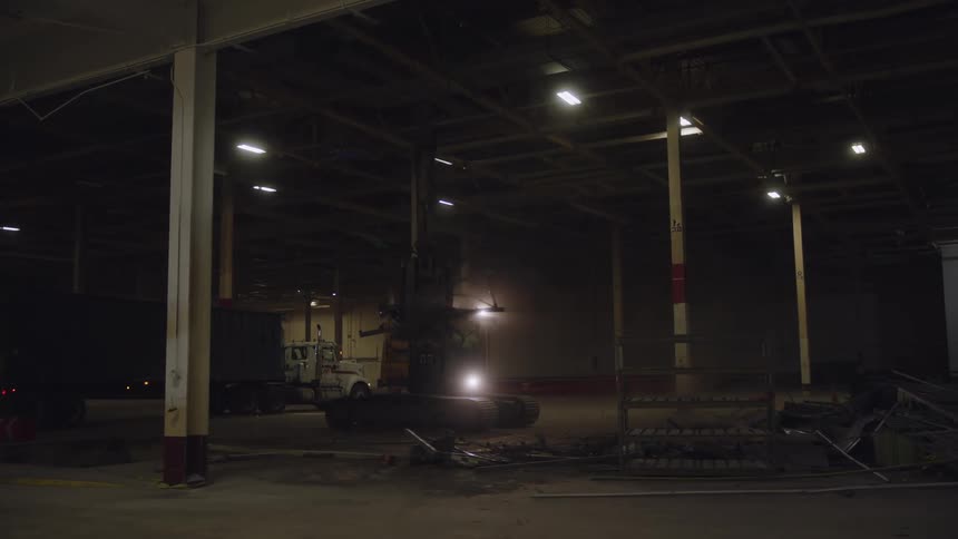 A forklift is used to remove debris in a building