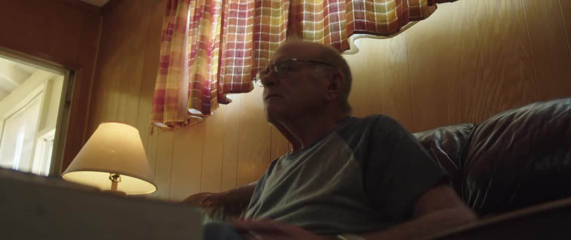 A man cheers at something he is watching
