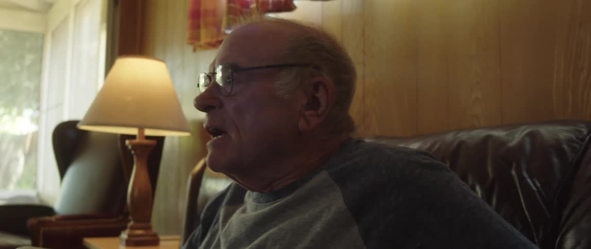 A man gets angry at something he is watching