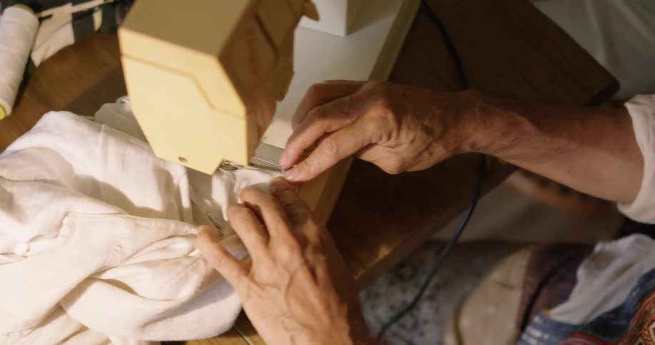 A person is using the sewing machine