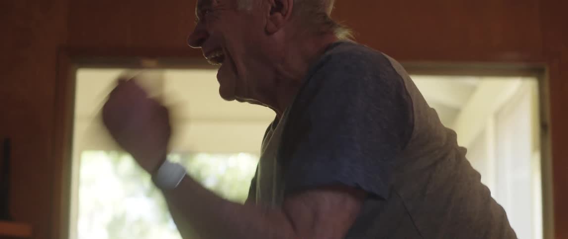 A man stands up and cheers