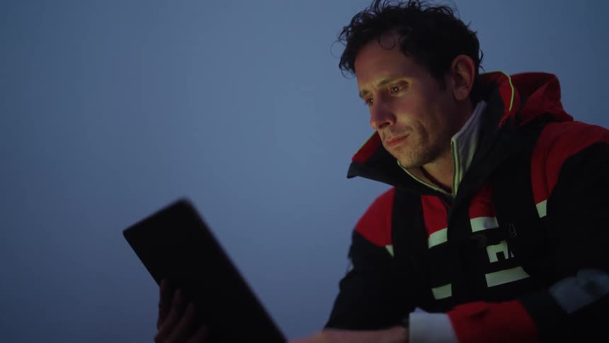 A man is using his tablet outside