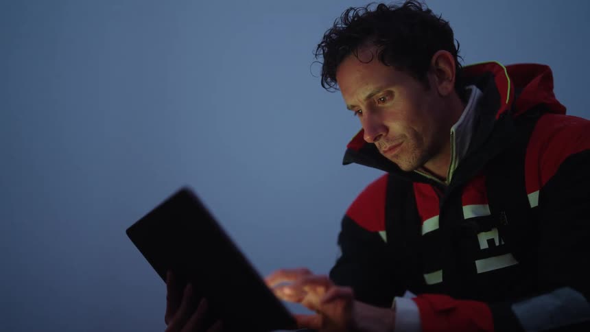 A man is using his tablet outside