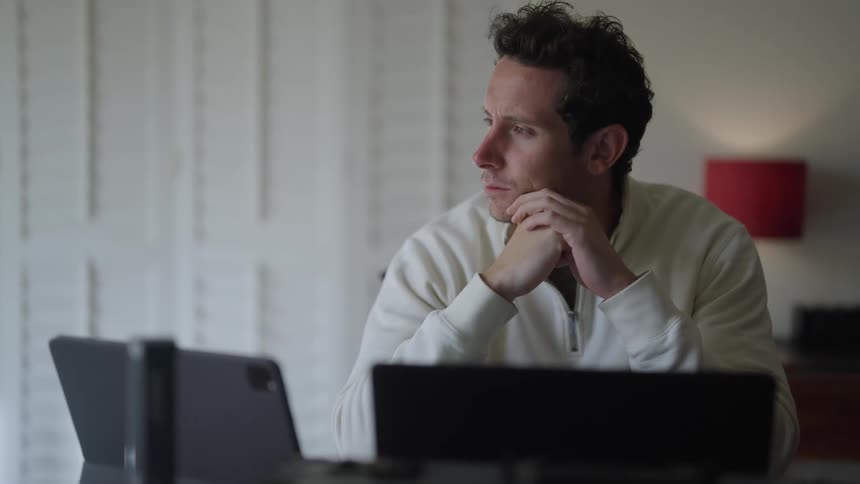 A man is working at his computers