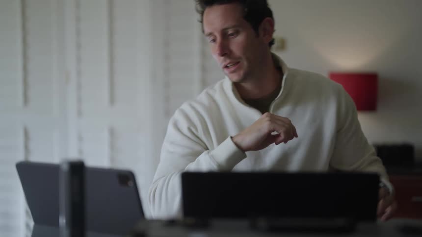 A man is talking on his computer