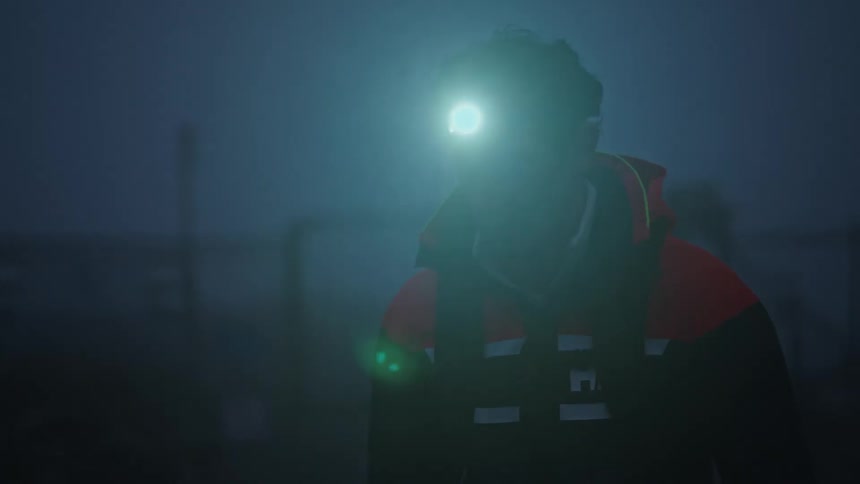 A man is hiking in the fog