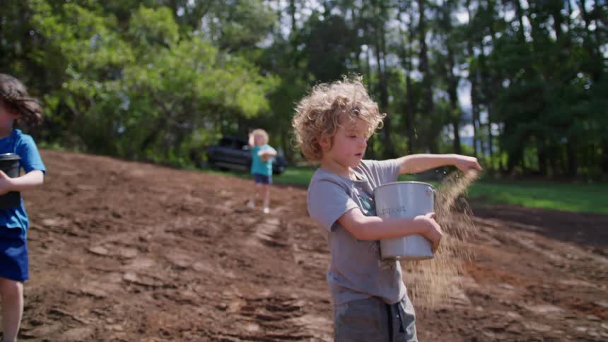 Children are spreading seeds on the farm