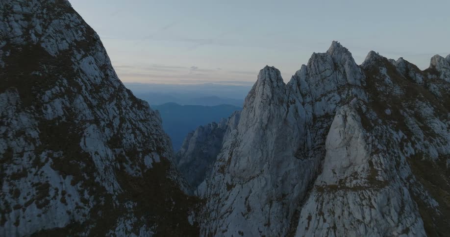 The tall mountains are covered with ice at the peak