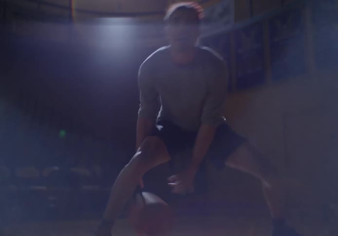 A man is dribbling the basketball