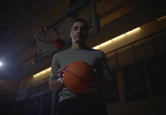 A man tosses a basketball around