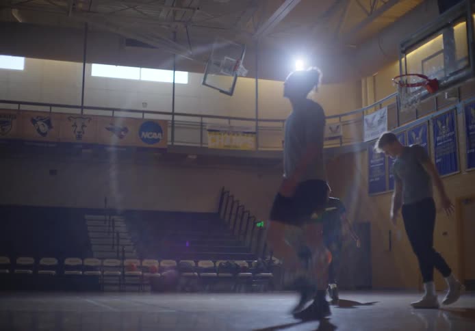 Three people are playing basketball