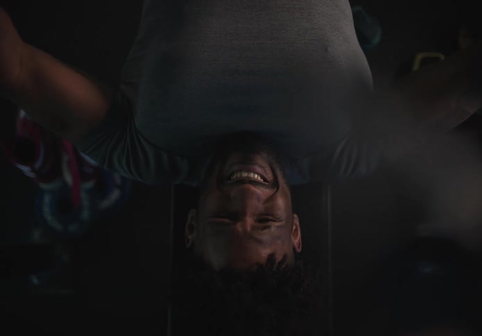 A man lifts a barbell while lying on a weight bench