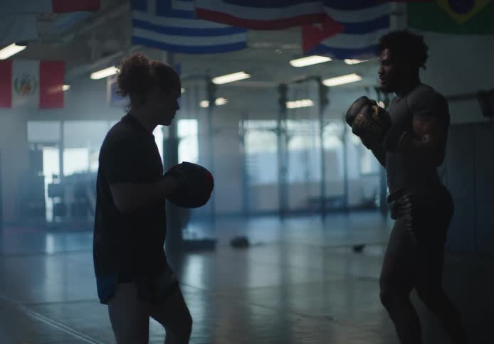 Two men are sparring in the gym
