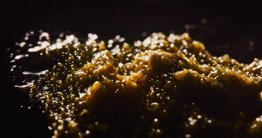 Yellow brown mass gels and increases on shiny black surface