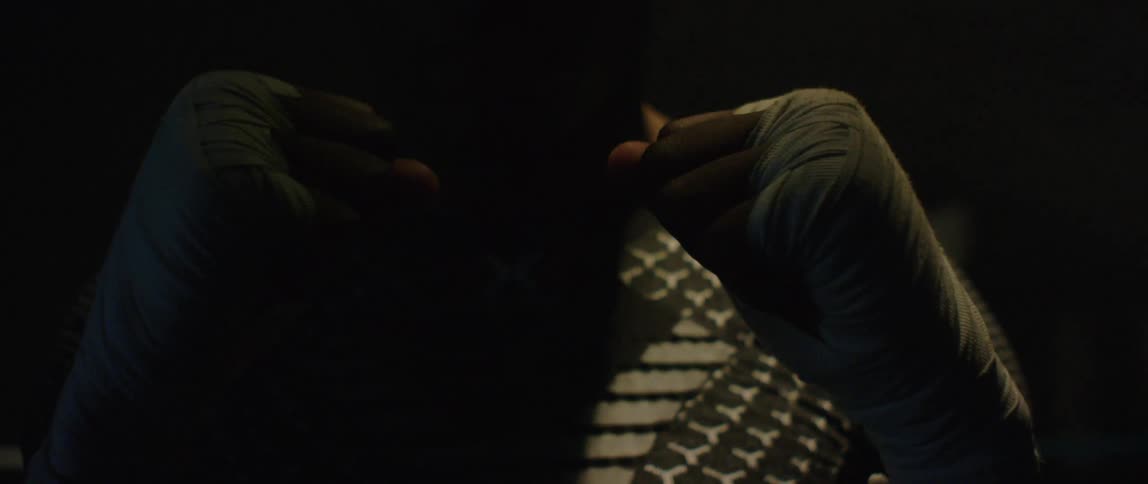 Black man with raised fists looking intently