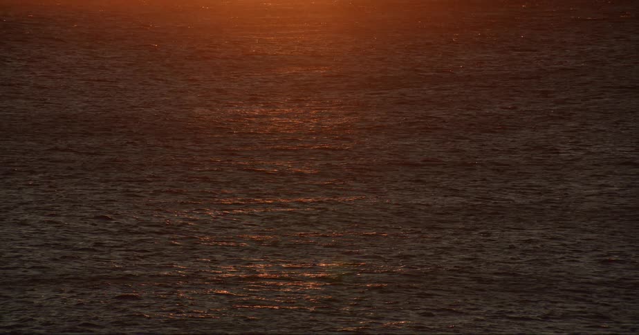 The light of the sun is seen as it shines upon the surface of the ocean