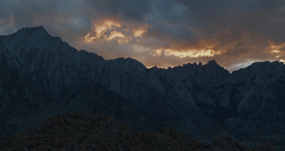 A mountain ridge under a cloudy daytime sky