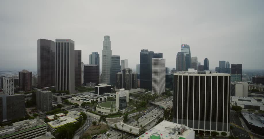 A large metropolitan city with the freeway and many buildings from an aerial view